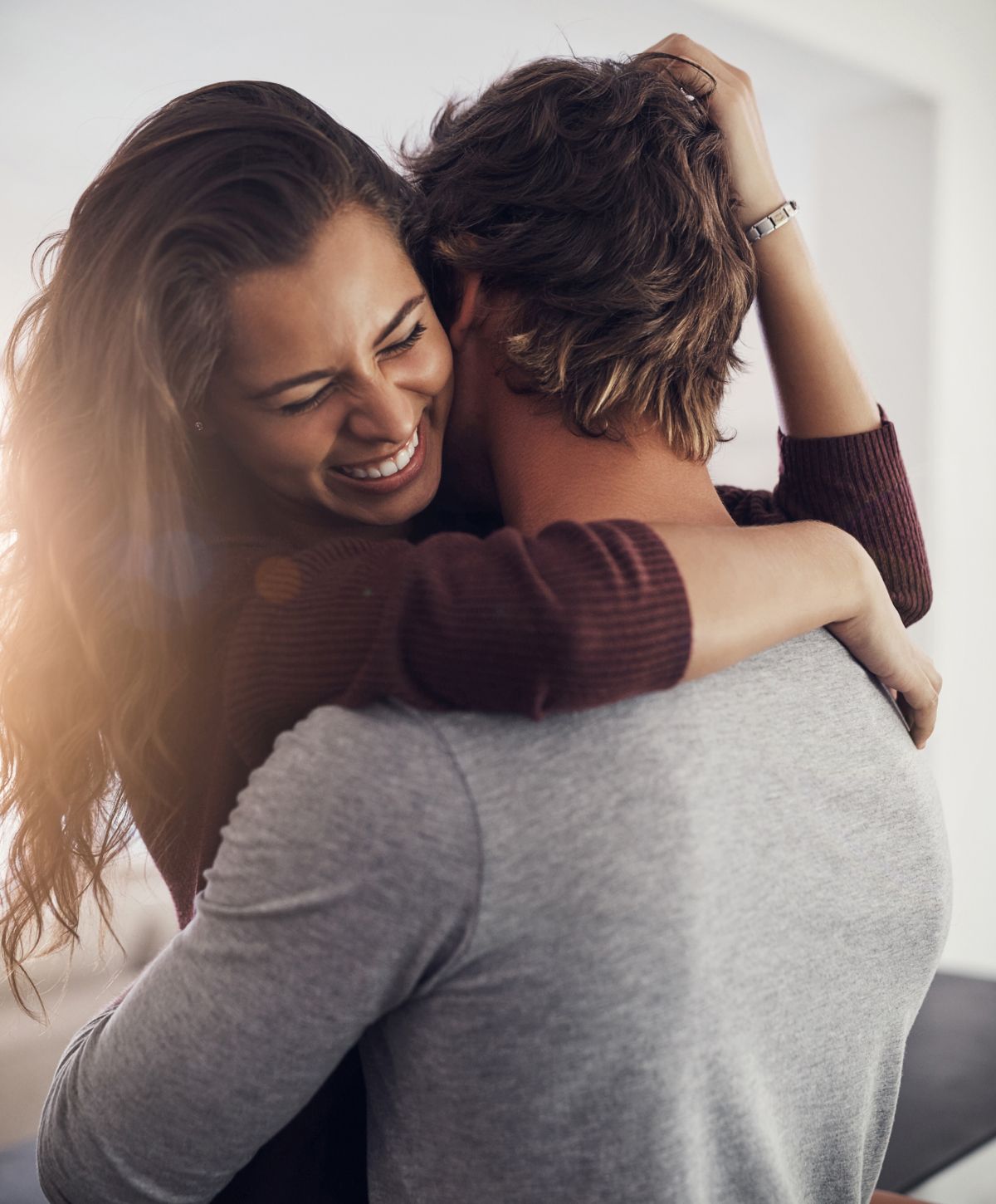 Alpharetta O Shot models embracing joyfully in a warm moment.